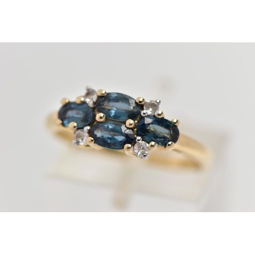 31 - A 9CT GOLD SAPPHIRE AND TOPAZ RING, set with four oval cut blue sapphires, each in a four claw yello... 