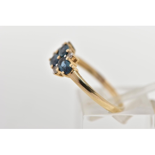 31 - A 9CT GOLD SAPPHIRE AND TOPAZ RING, set with four oval cut blue sapphires, each in a four claw yello... 