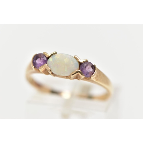 37 - A 9CT OPAL AND CUBIC ZIRCONIA RING, centring on an oval cut opal, tension set, flanked with circular... 