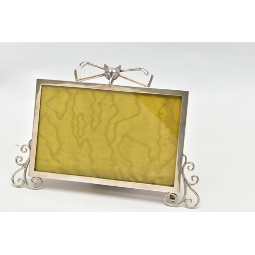 58 - AN EARLY 20TH CENTURY SILVER PHOTOFRAME, polished frame detailed with scroll work to the bottom corn... 