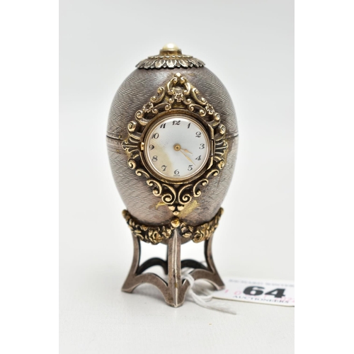 64 - A 'ST JAMES HOUSE COMPANY' SILVER EASTER EGG CLOCK,  featuring a small round clock with a white dial... 