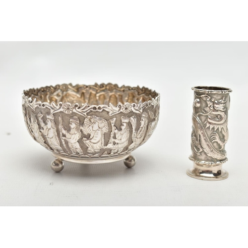 83 - AN EMBOSSED WHITE METAL BOWL AND SMALL VASE, the round bowl decorated with embossed multiple figural... 