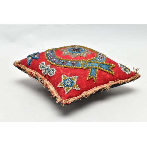 931A - A LATE VICTORIAN VELVET BEADWORK PIN CUSHION OF SQUARE FORM WITH ORDER OF THE GARTER TO THE CENTRE, ... 