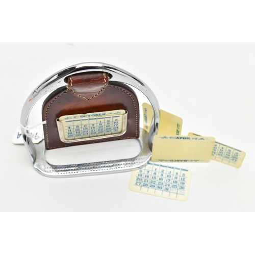 946A - A CHROME AND BROWN LEATHER PERPETUAL CALENDAR IN THE FORM OF A STIRRUP, with six interchangeable mon... 