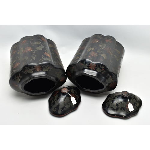 999A - A PAIR OF ORIENTAL BLACK LACQUERED PAPIER MACHE TEA CANNISTERS AND COVERS OF SHAPED OVAL FORM, the d... 