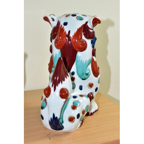 301 - AN ORIENTAL STYLE DOG OF FO CERAMIC FIGURE, in seated position, decorated with red, green and blue s... 