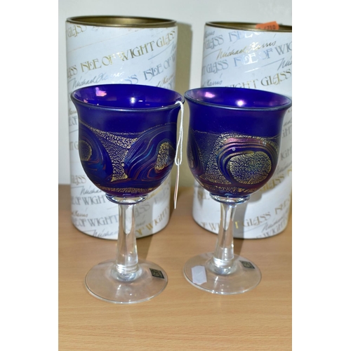 302 - TWO BOXED ISLE OF WIGHT WINE GLASSES, each bowl in blue glass with a gold band and iridescent looped... 