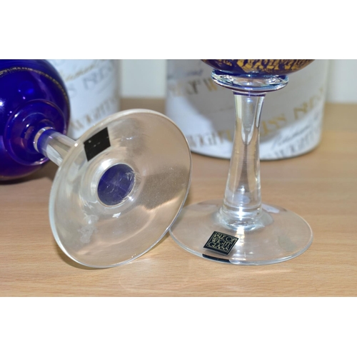 302 - TWO BOXED ISLE OF WIGHT WINE GLASSES, each bowl in blue glass with a gold band and iridescent looped... 