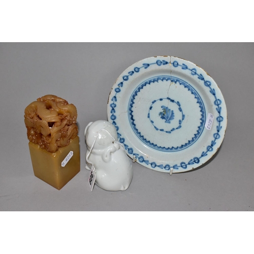 309 - AN EIGHTEENTH CENTURY DELFT PLATE AND ORIENTAL ITEMS, comprising a carved stone table seal with drag... 