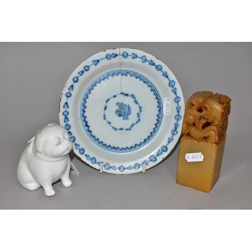 309 - AN EIGHTEENTH CENTURY DELFT PLATE AND ORIENTAL ITEMS, comprising a carved stone table seal with drag... 