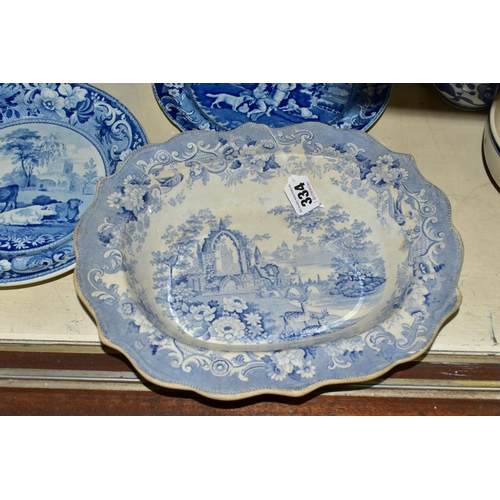 334 - FOUR PIECES OF ANTIQUE BLUE AND WHITE TRANSFER WARES, to include a meat plate printed with a rural v... 