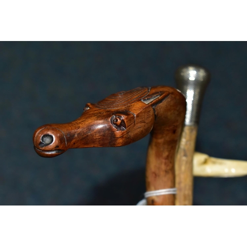 339 - A GROUP OF EARLY 20TH CENTURY CANES AND HORSE CROP, comprising a silver topped cane, monogramed AHS,... 