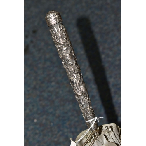 340 - A CHINESE SILVER AND GREY UMBRELLA/PARASOL, with a white metal handle embossed with Dragons, length ... 