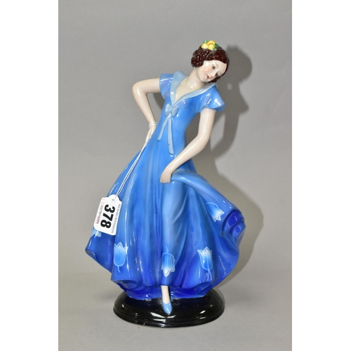 378 - A 1930'S CONTINENTAL PORCELAIN FIGURE OF A LADY IN A LONG BLUE DRESS, modelled standing on an oval b... 