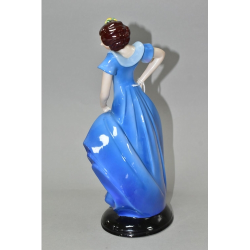 378 - A 1930'S CONTINENTAL PORCELAIN FIGURE OF A LADY IN A LONG BLUE DRESS, modelled standing on an oval b... 