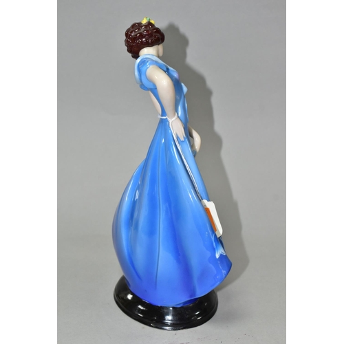 378 - A 1930'S CONTINENTAL PORCELAIN FIGURE OF A LADY IN A LONG BLUE DRESS, modelled standing on an oval b... 