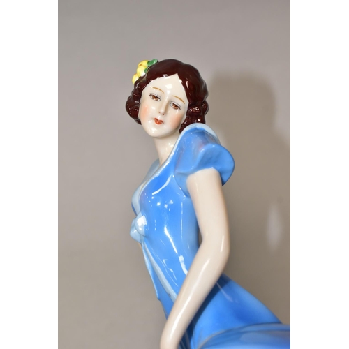 378 - A 1930'S CONTINENTAL PORCELAIN FIGURE OF A LADY IN A LONG BLUE DRESS, modelled standing on an oval b... 