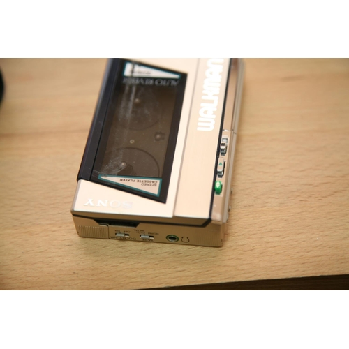 878 - A SONY WM-40 STEREO CASSETTE PLAYER with padded case condition is very good, motor turns but tape do... 