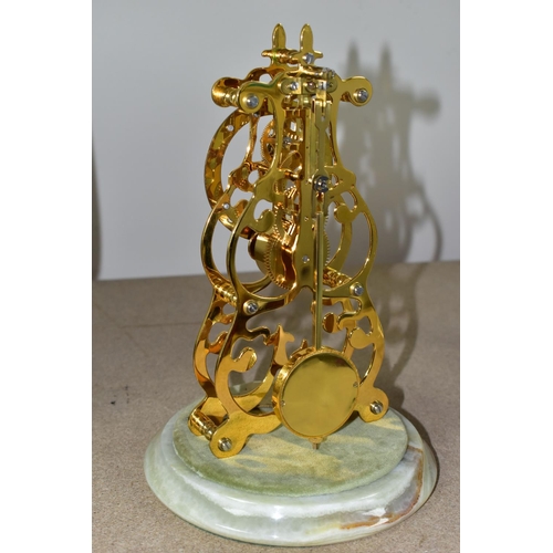 426 - A GLASS DOMED SKELETON CLOCK, with a loose makers label 'Thwaites & Reed', on a green onyx base, hei... 