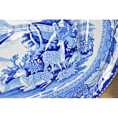 429 - A LARGE BLUE AND WHITE  PLATTER, decorated with a pastoral scene, Fallow deer in foreground, length ... 