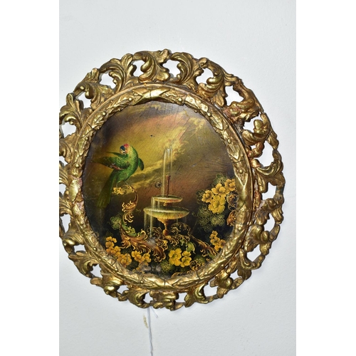 437 - A 19TH CENTURY GILT FRAMED OVAL PAPIER MACHÉ PAINTING, of an exotic parrot, fountain and foliate des... 