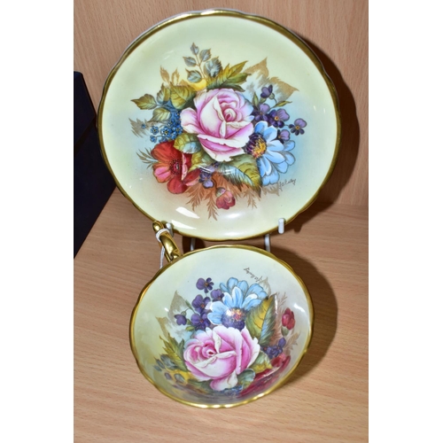 449 - AN AYNSLEY FLORAL DECORATED TEA CUP AND SAUCER BY J. A. BAILEY, with wavy rims, cup having gilt exte... 