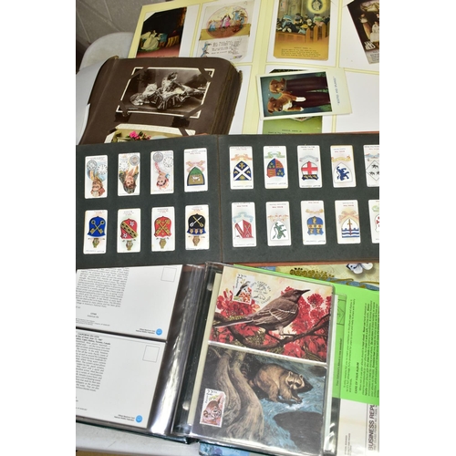 523 - POSTCARDS, 1st DAY COVERS & EPHEMERA, three albums containing approximately 310 postcards dating fro... 