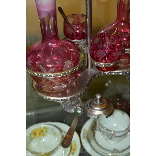 536 - A PINK STAINED GLASS AND PLATED CRUET, the stand fitted with two bottles and two preserve pots, cut ... 