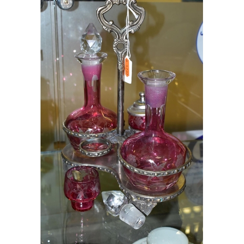 536 - A PINK STAINED GLASS AND PLATED CRUET, the stand fitted with two bottles and two preserve pots, cut ... 