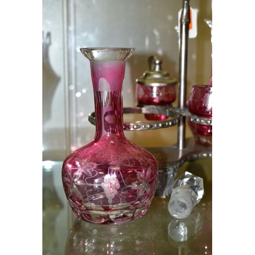 536 - A PINK STAINED GLASS AND PLATED CRUET, the stand fitted with two bottles and two preserve pots, cut ... 