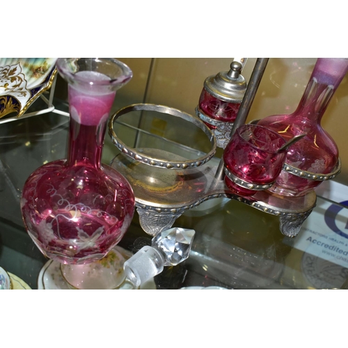 536 - A PINK STAINED GLASS AND PLATED CRUET, the stand fitted with two bottles and two preserve pots, cut ... 