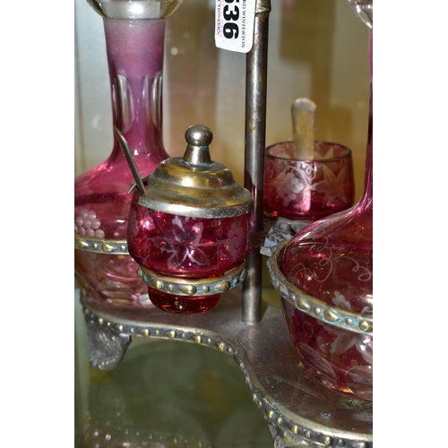 536 - A PINK STAINED GLASS AND PLATED CRUET, the stand fitted with two bottles and two preserve pots, cut ... 