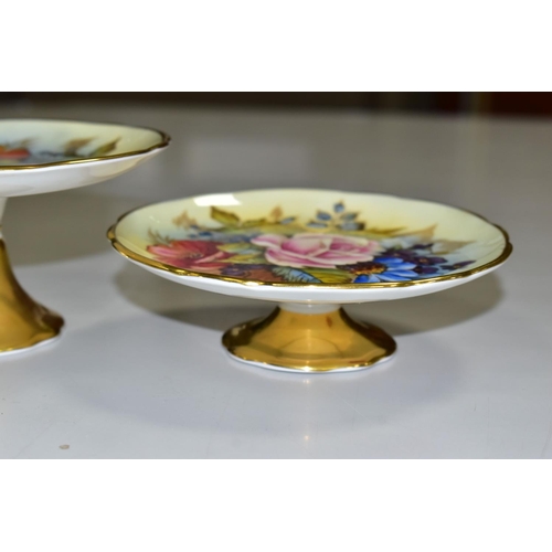 539 - TWO AYNSLEY FLORAL DECORATED PEDESTAL DISHES BY J. A. BAILEY, with wavy rims and gilt bases, both be... 