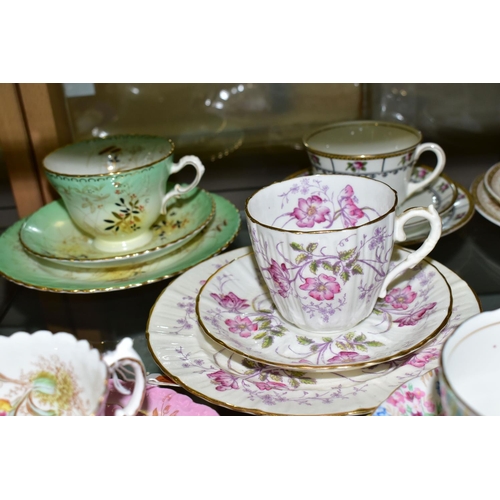 553 - A GROUP OF AYNSLEY AND OTHER TRIOS, CUPS AND SAUCERS, assorted patterns to include a pink rimmed tri... 