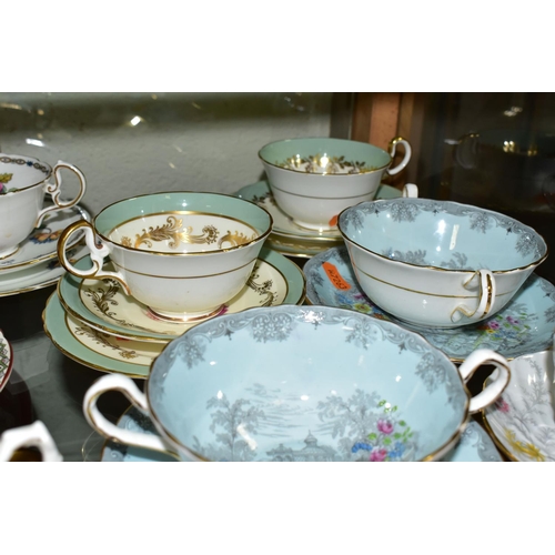 554 - A GROUP OF AYNSLEY TRIOS  AND SOUP BOWLS,  comprising two soup bowls with two saucers in the 'Queen'... 