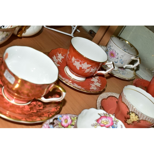 555 - TWENTY ONE AYNSLEY TEA CUPS AND SAUCERS, assorted patterns including florals, gilt bands and solid c... 