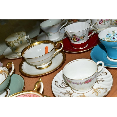 555 - TWENTY ONE AYNSLEY TEA CUPS AND SAUCERS, assorted patterns including florals, gilt bands and solid c... 