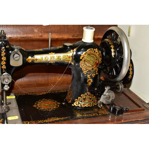 559 - AN EDWARDIAN JONES SEWING MACHINE, with a wooden carry case, model No. 288479 as supplied to her Maj... 