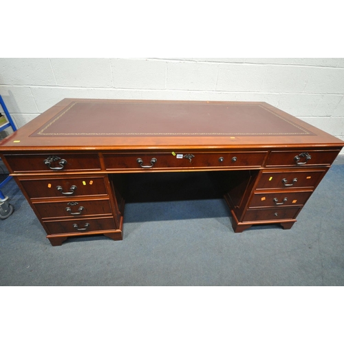 1202 - A 20TH CENTURY CHERRYWOOD TWIN PEDESTAL DESK, with burgundy and tooled leather writing surface, and ... 