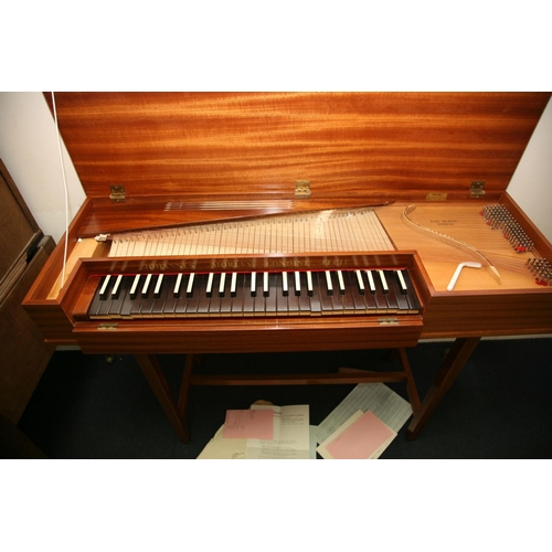 879 - A JOHN MORLEY BACH CLAVICHORD in a medium Walnut Veneered finish, ebony keys with receipts and paper... 