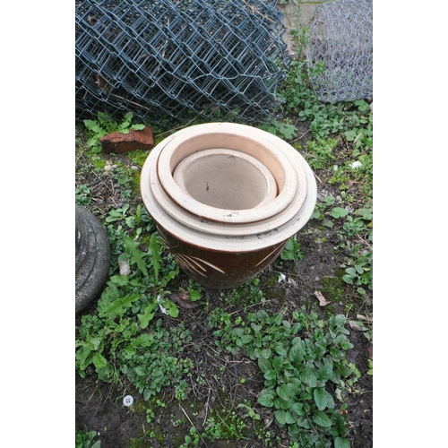 1007 - A BRASS SUNDIAL ON A COMPOSITE COLUMN, a composite base, four graduated brown glazed plant pots and ... 