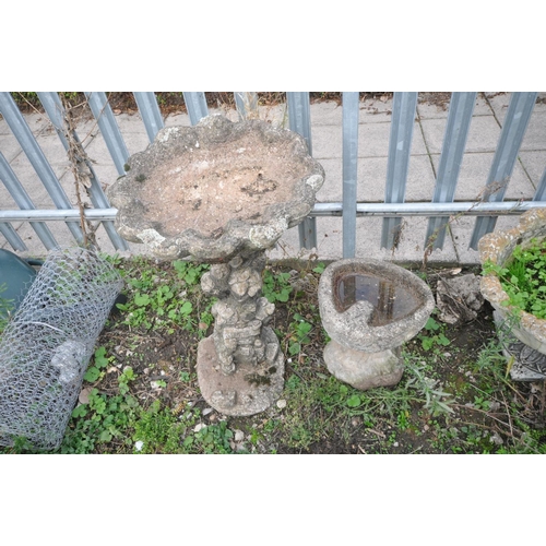 1008 - TWO COMPOSITE BIRD BATHS one in the form of an oyster shell on top of a tree stump height, 70cm