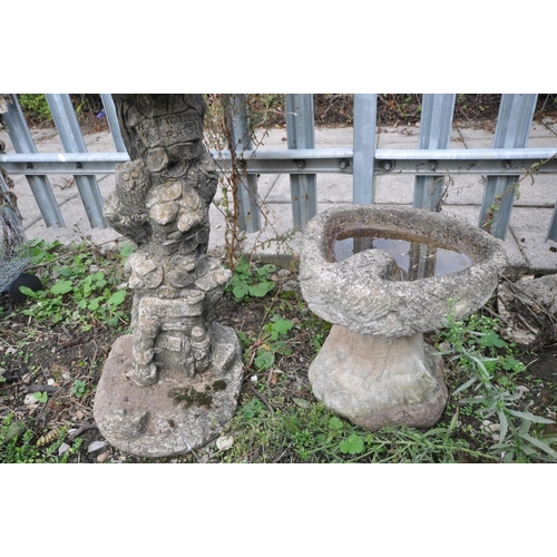 1008 - TWO COMPOSITE BIRD BATHS one in the form of an oyster shell on top of a tree stump height, 70cm