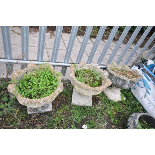 1009 - THREE COMPOSITE GARDEN URNS in the form of an Acanthus leaf bowl on a separate base height 45cm