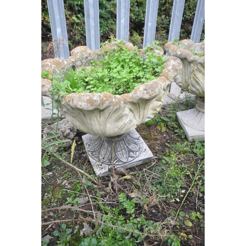 1009 - THREE COMPOSITE GARDEN URNS in the form of an Acanthus leaf bowl on a separate base height 45cm