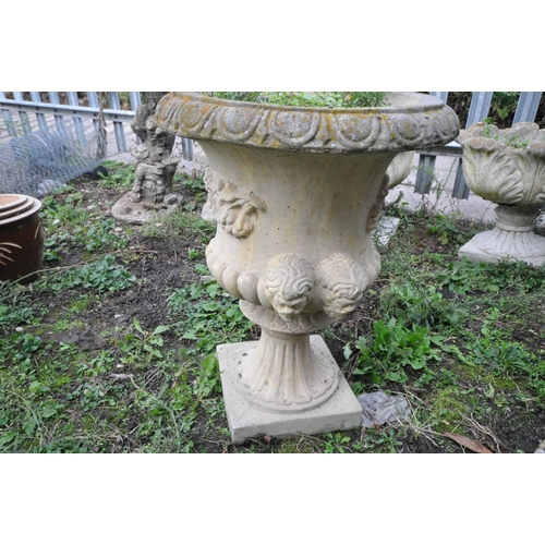 1010 - A COMPOSITE CAMPAGNA STYLE GARDEN URN with twin mask handles height 65cm