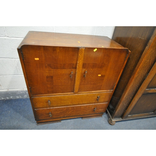 1203 - A 20TH CENTURY OAK TWO DOOR WARDROBE, the doors with a floral plaque, on bun feet, width 122cm x dep... 