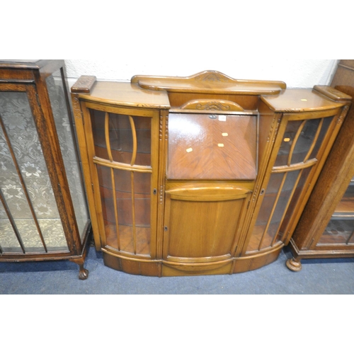 1205 - A 20TH CENTURY OAK SIDE BY SIDE BUREAU BOOKCASE, two glazed doors flanking a fall front door, above ... 