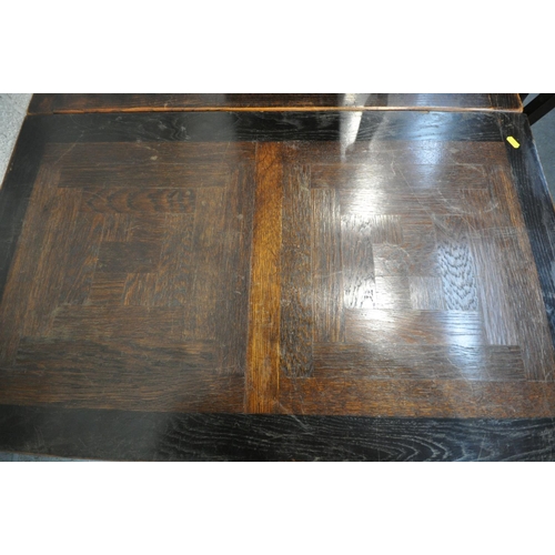 1211 - AN OAK FRENCH EXTENDING DINING TABLE, on twin acorn supports, united by a single stretcher, extended... 