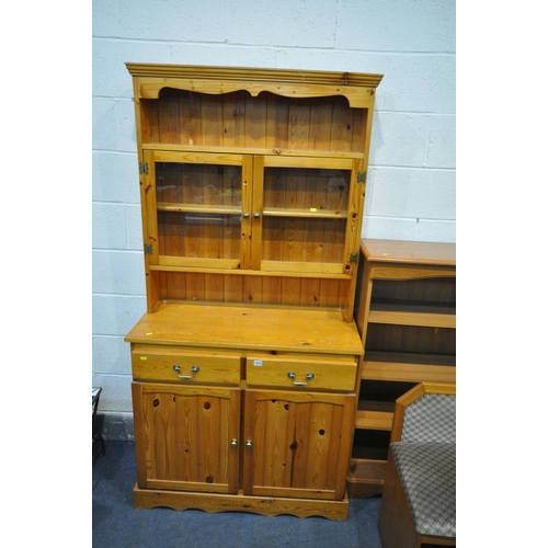 1213 - A PINE BOOKCASE, top with two glazed doors, base with two drawers over two doors, width 95cm x depth... 